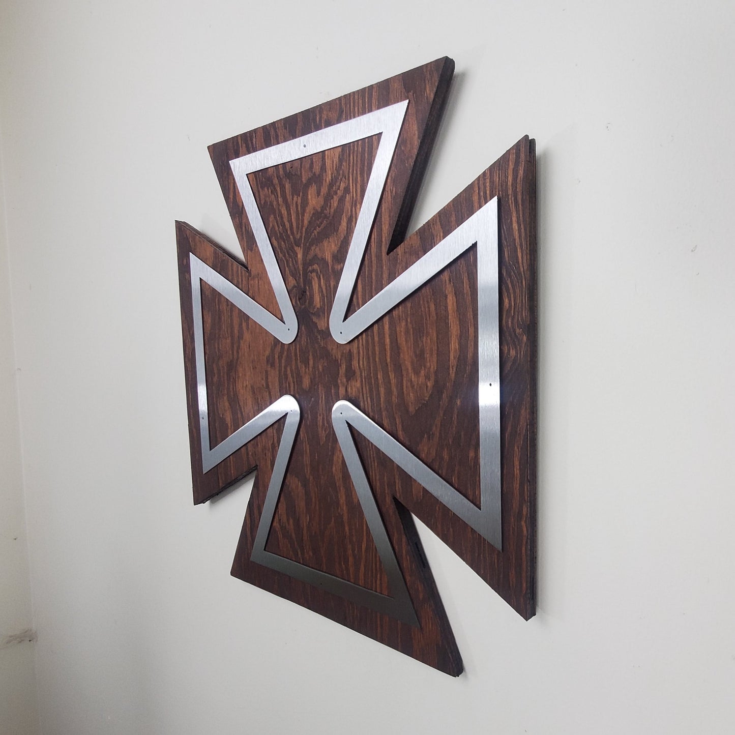 Maltese Cross metal art on wood side view